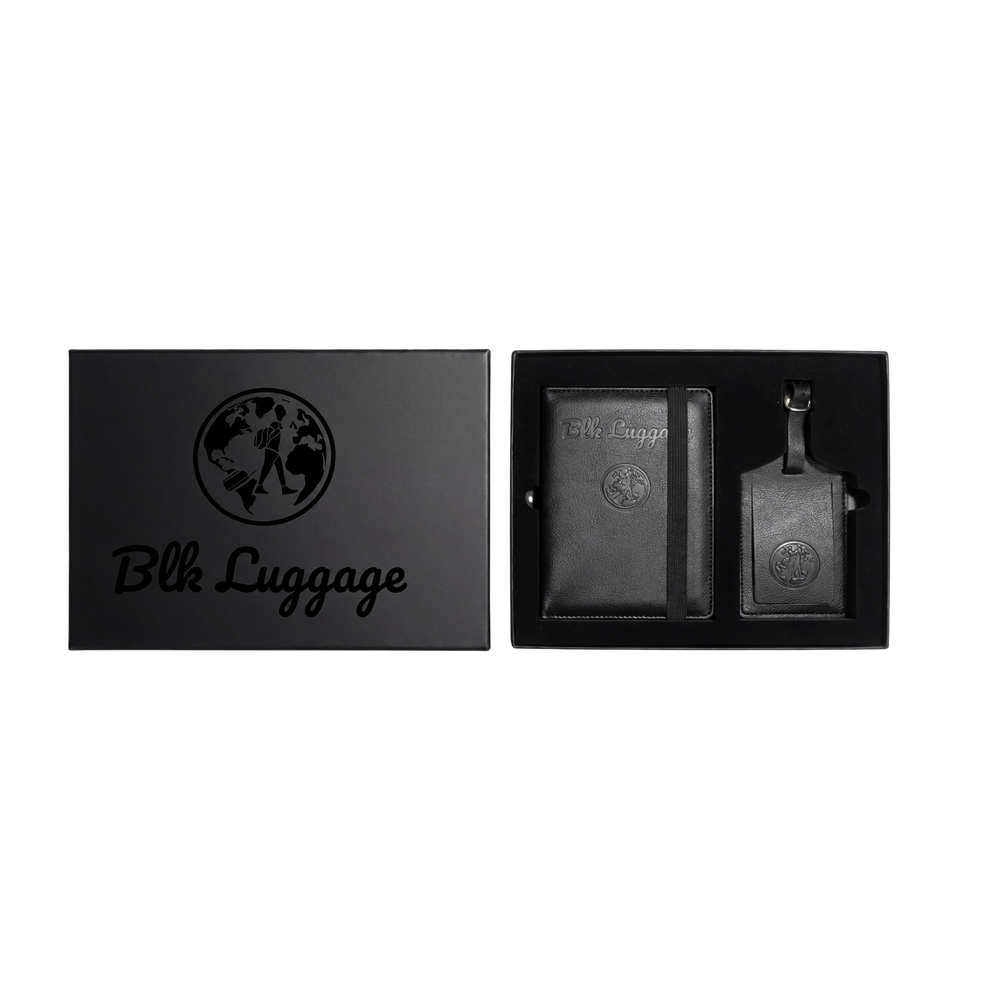 The Departure black passport holder and luggage tag in a branded gift box.