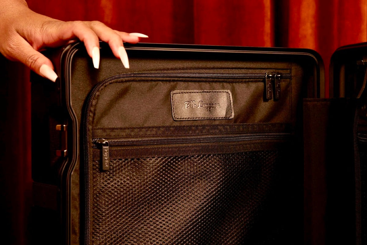 BLK Luggage interior craftsmanship — luxury lining, mesh pockets, and vegan leather badge